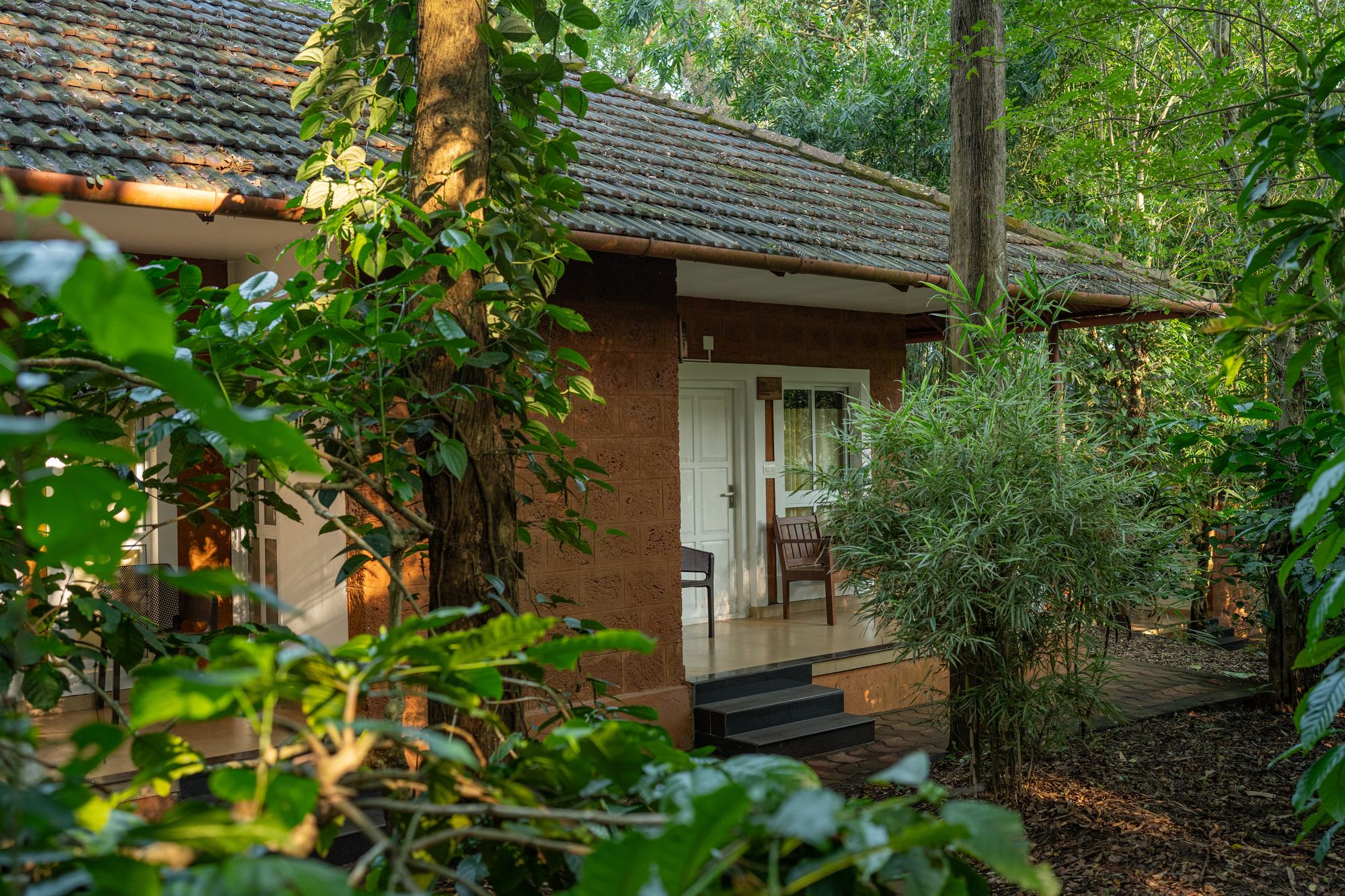 Traditional cottage with laterite walls and a red clay-tiled roof