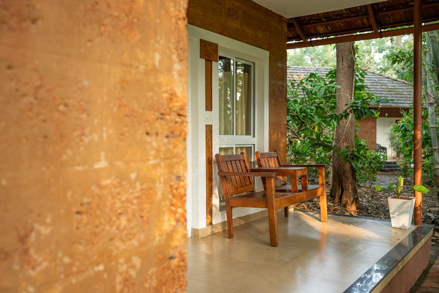 Cottage veranda with chairs looking out into the garden